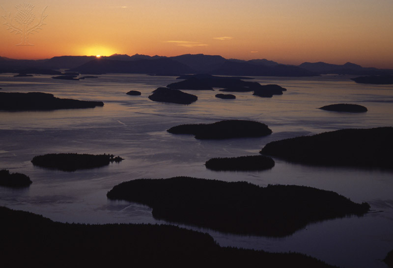 SAN JUAN ISLANDS at dusk Wasp Islands, aerial view Sun setting ovr Vancouver Island Washington, USA